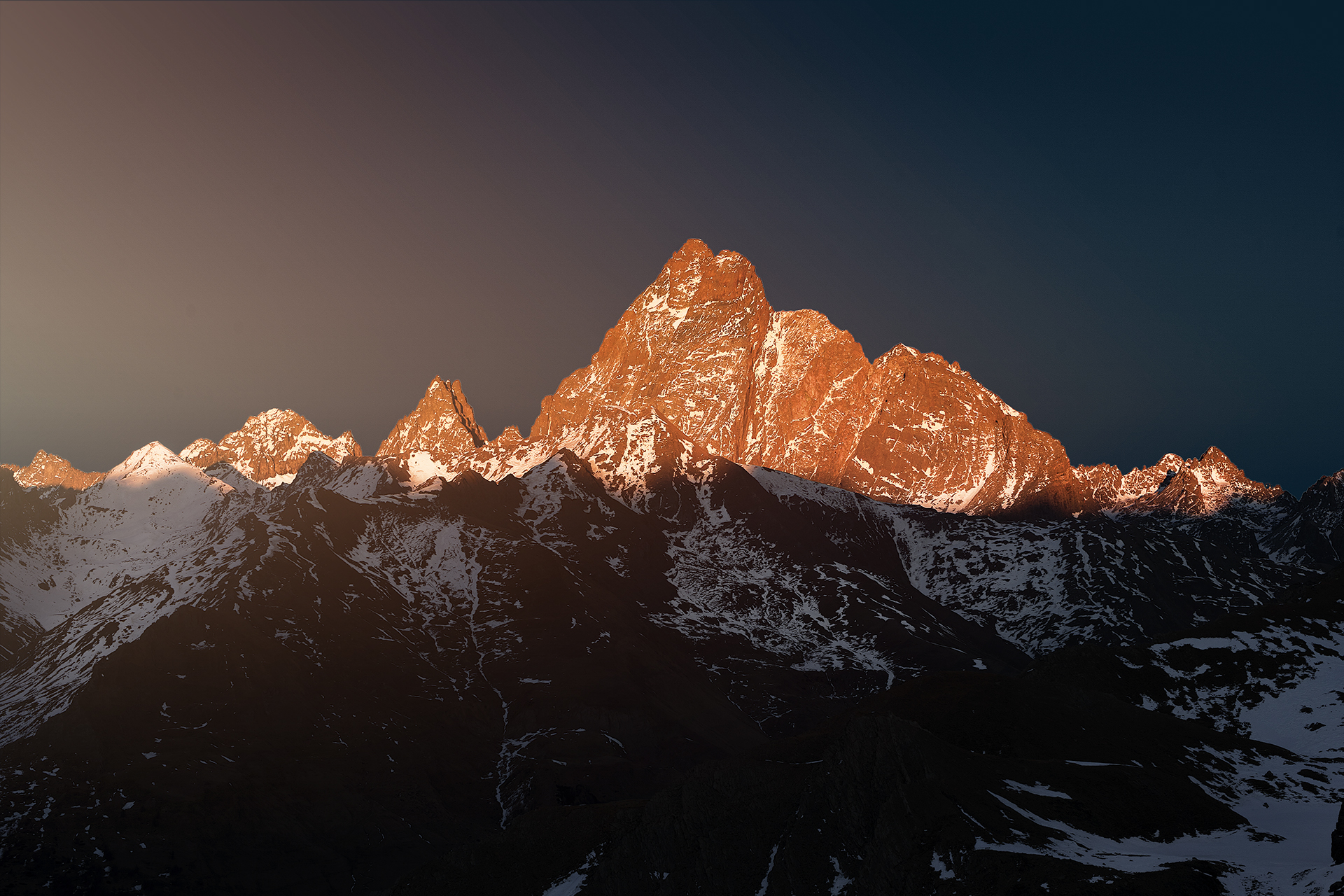 Monviso west face lit by sunset in winter seen from Colle del Longet (2750m)