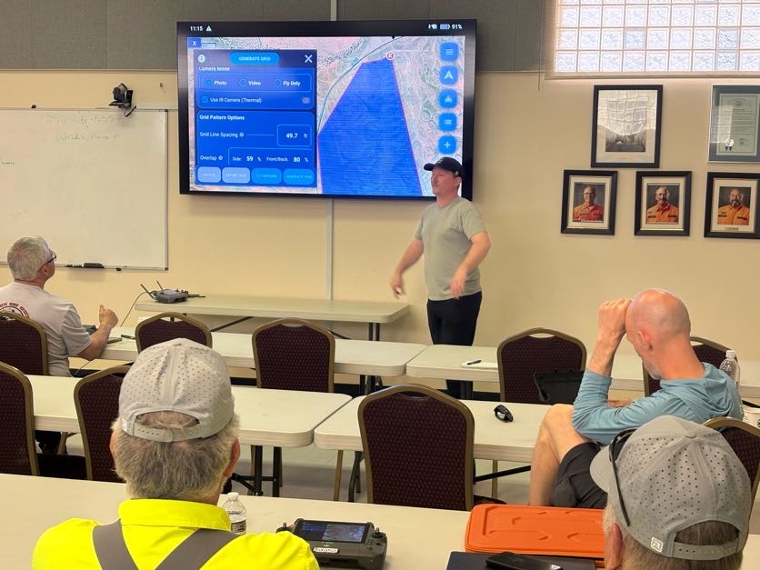 Instructor teaching Eagle Eyes Pilot mission planning to a SAR team