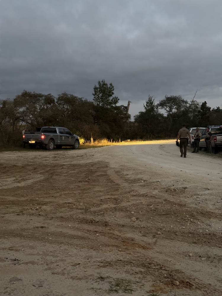 SAR team running a night search exercise under a drone spotlight